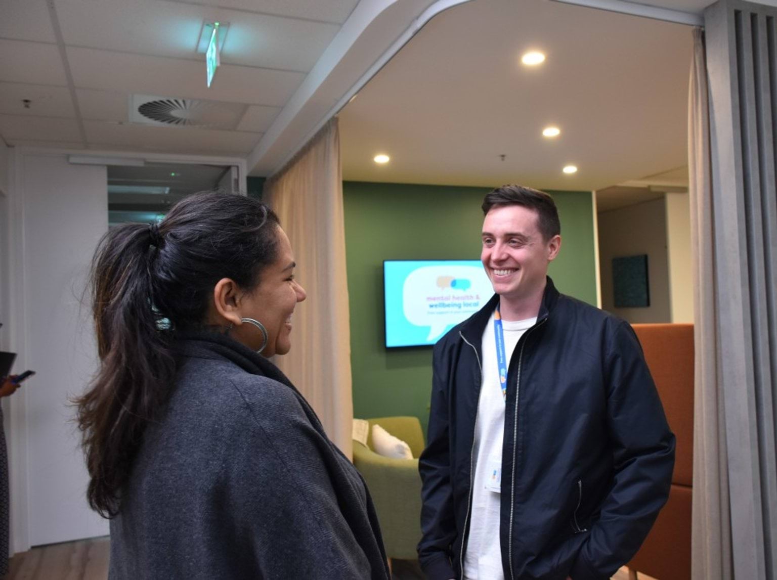 Two people chatting. At least one is a healthcare professional