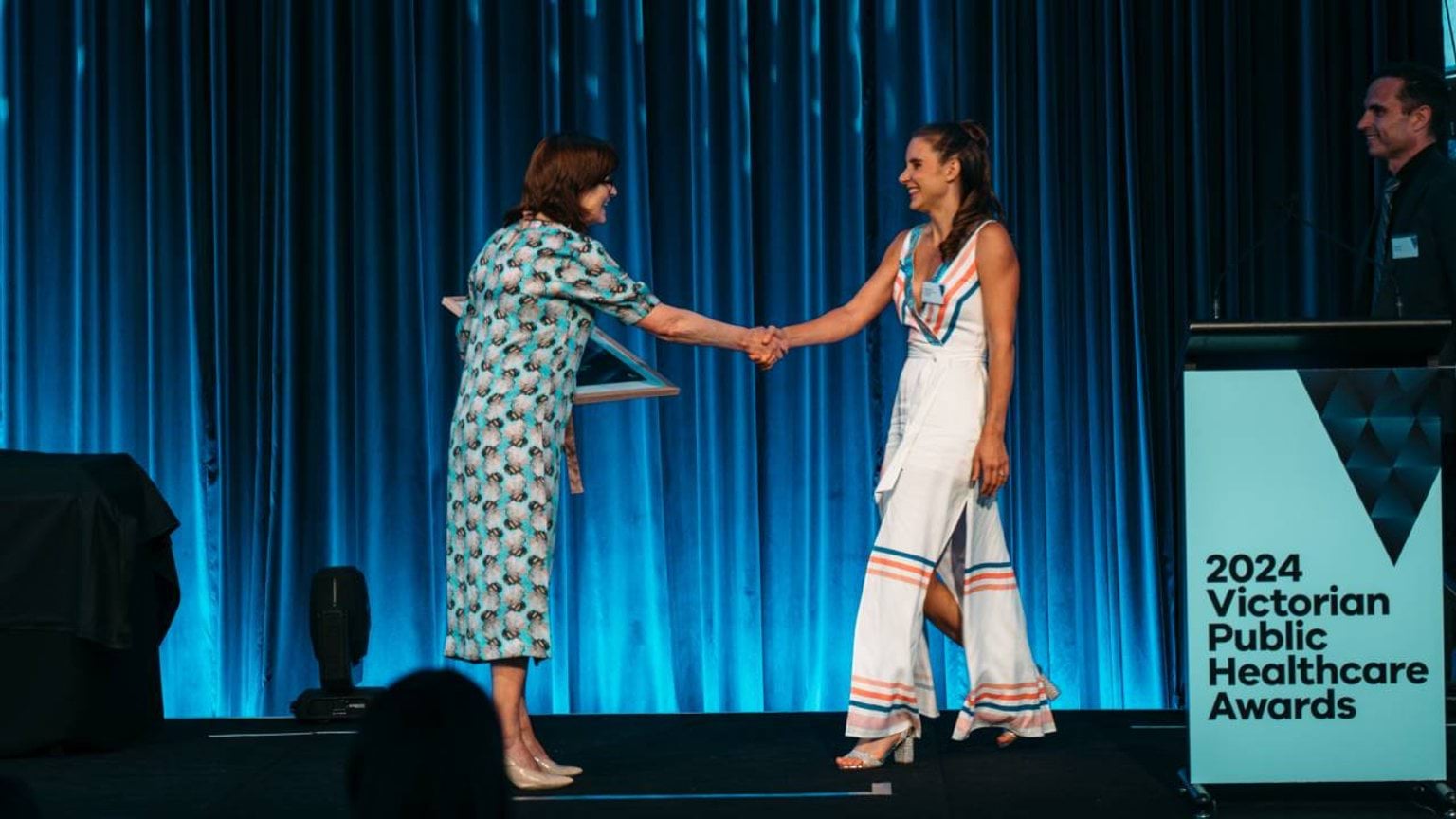 An award winner shakes hands