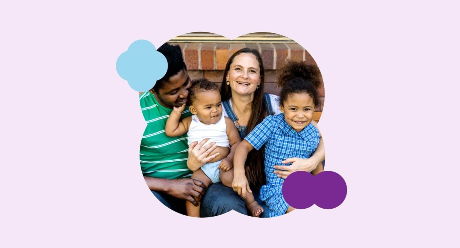 Two parents hugging their smiling children.