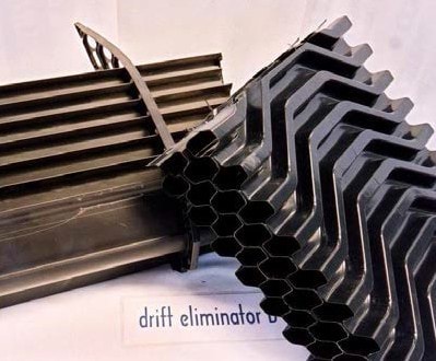 photo 1: Cooling tower with basin exposed to sunlight: This cooling tower does not have sunlight protection to the side and basin of the towerphoto 2: Automated biocide dosing: This device has a timer which controls a pump to inject a pre-set volume of biocide into the waterphoto 3: Drift eliminator: a typical modern drift eliminatorphoto 4: Modern fill: Fill made of materials such as polypropylene is now available for retrofitting to most types of cooling towers.